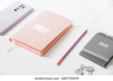 Composition On Office Table From Notebook Calendar And Smartphone. Plans And Goals For The Next Year 2022.