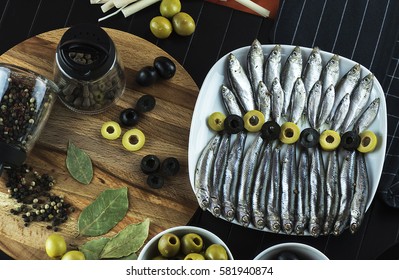 The composition on the table of the little fish, the anchovy and olives