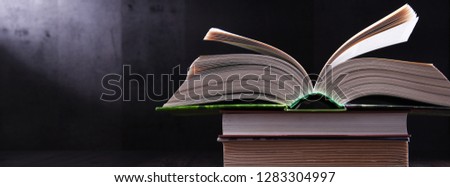 Composition with open book on the table.
