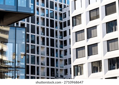 Composition of overlapping modern white stone and glass building facades near Alexanderplatz, Berlin. Geometric urban architecture with balconies.