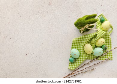 Composition with painted Easter eggs, bunny and pussy willow branches on light background