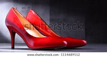 Composition with a pair of red high heel shoes.