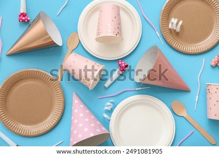 Composition with paper disposable tableware and decor for birthday party on color background