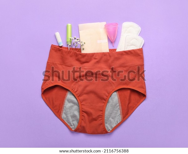 Composition with period panties, pads, tampons\
and menstrual cup on lilac\
background