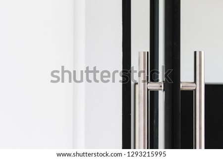 Composition Photo of Aluminium Framed Door with Stainless Steel Door Handle in an Office Expressing Formality