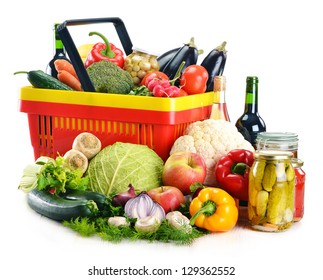 Composition with plastic shopping basket and grocery isolated on white - Shutterstock ID 129362552