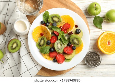 Composition With Plate Of Fresh Fruit Salad On White Wooden Table, Top View