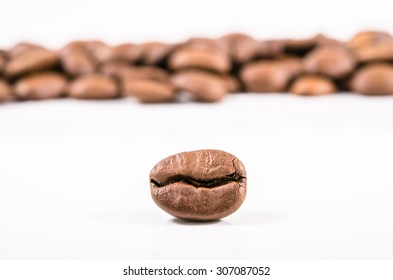 Composition of roasted coffee beans close-up on a white background