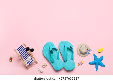 Composition with seashells, decorative flip-flops, hat and deckchair on pink background