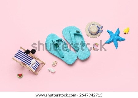 Composition with seashells, decorative flip-flops, hat and deckchair on pink background