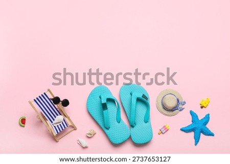 Composition with seashells, decorative flip-flops, hat and deckchair on pink background