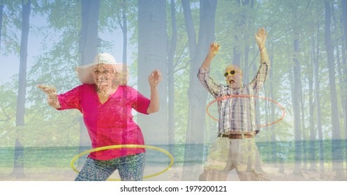 Composition of senior couple hula hooping on beach and trees in sunlight. healthy active retirement lifestyle concept digitally generated image. - Powered by Shutterstock