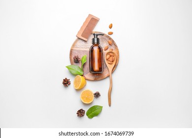 Composition With Shampoo, Natural Ingredients And Comb On White Background