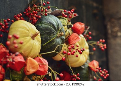 Composition of the small pumpkins and zucchinis on a vintage door Halloween pumpkins