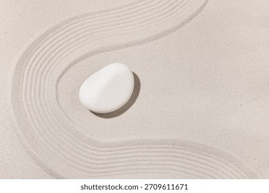Composition with spa stone and lines on sand as background, closeup. Zen concept