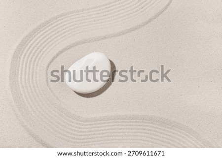 Composition with spa stone and lines on sand as background, closeup. Zen concept