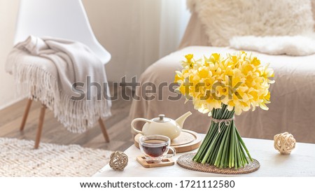 Composition with spring flowers in a cozy living room interior . The concept of decor and comfort.