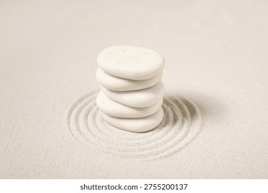 Composition with stack of spa stones and lines on sand as background, closeup. Zen concept