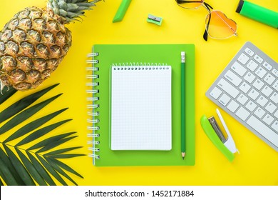 Composition with stationery, pineapple and computer keyboard on color background