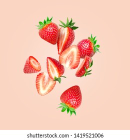 The composition of strawberries on a colored background. Cut strawberries into pieces with copy space. Fresh natural strawberry isolated. Strawberry slices flying in the air