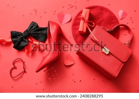 Composition with stylish female accessories, shoe and gift box for Valentine's Day celebration on red background