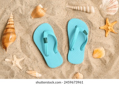 Composition with stylish flip-flops and seashells on sand