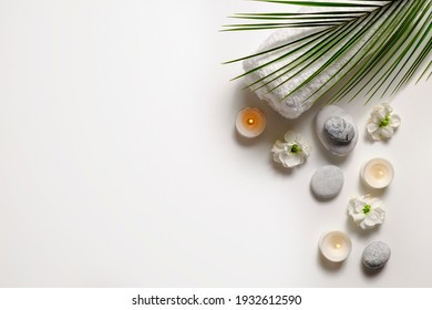 Composition and symbolic objects for spa salon  Stone therapy attributes for cosmetic procedures  Conceptual image  rocks   flowers representing balance  Close up  copy space  top view  background 
