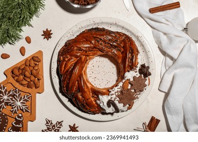 Composition with tasty Christmas pastry wreath, cookies, nuts and spices on light background - Shutterstock ID 2369941493