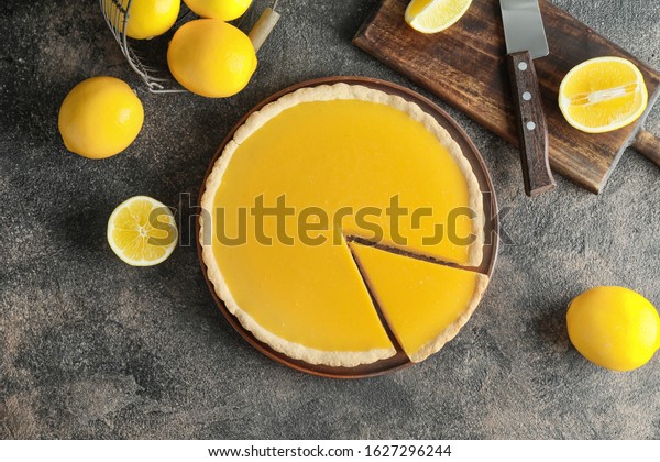 Composition with tasty\
lemon pie on table
