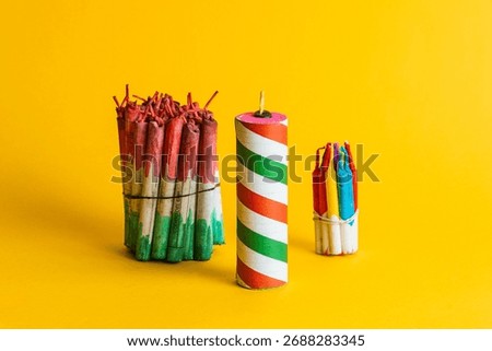 Composition of three bundles of pyrotechnics and a large striped firecracker, highlighting the celebration colors on a yellow background.