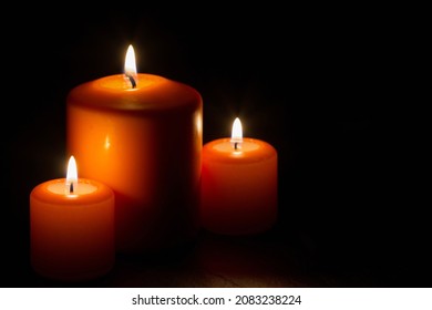 Composition of three burning candles on dark background - Powered by Shutterstock