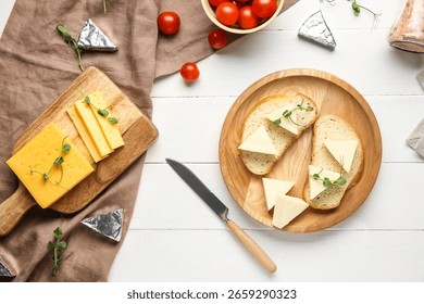 Composition with triangles of tasty processed cheese, bread and tomatoes on light wooden background