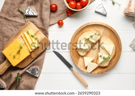Composition with triangles of tasty processed cheese, bread and tomatoes on light wooden background