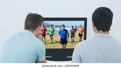 Composition Of Two Male Sports Fans Watching Football Match On Tv. Sport And Competition Concept Digitally Generated Image.