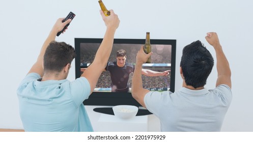 Composition Of Two Male Sports Fans Watching Football Match On Tv. Sport And Competition Concept Digitally Generated Image.