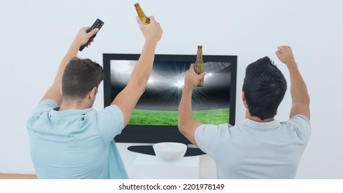 Composition Of Two Male Sports Fans Watching Sports Stadium On Tv. Sport And Competition Concept Digitally Generated Image.