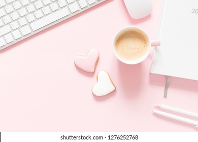 Composition Valentine's Day. Female desktop сomputer keyboard, сup of coffee and ginger cookie in shape heart on pastel pink background. Valentine day concept, design.  - Powered by Shutterstock