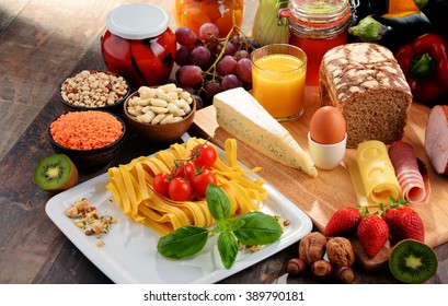 Composition with variety of organic food products on kitchen table