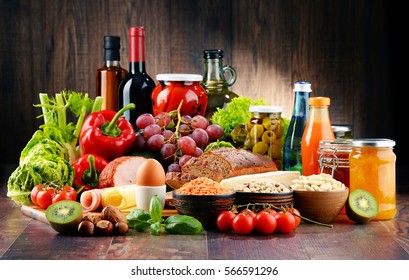 Composition with variety of organic food products on kitchen table - Shutterstock ID 566591296