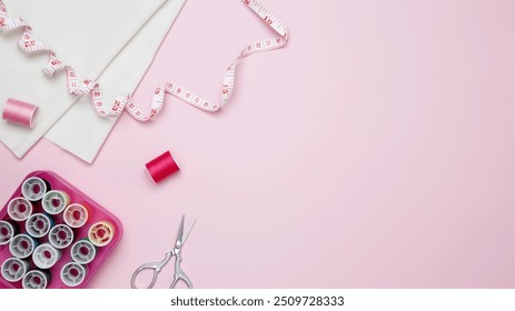 Composition with various threads and sewing accessories on pink background. Top view, copy space