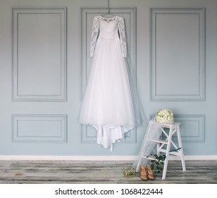 composition - wedding dress on a gray blue wall with decor and accessories - Powered by Shutterstock