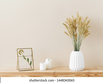 Composition Of White Ceramic Vase With Bouquet Of Dry Spikelets, Golden Photo Frame With Dried Flower, Candles On Wooden Table On Pastel Beige Background. Stylish Home Decor. Modern Interior Design.