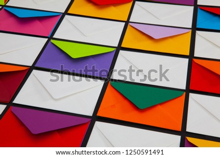 Composition with white and colored envelopes on the table. The photo suitable for various holidays and anniversaries.