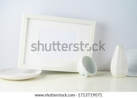 Composition with white objects and photo frame
