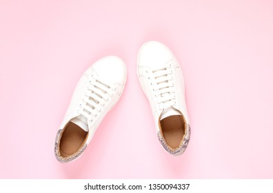 Composition of white sneakers on pastel pink background. Flat lay, top view minimal background - Shutterstock ID 1350094337