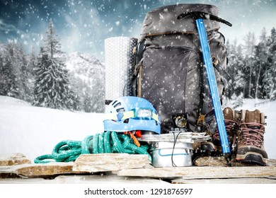 Composition of winter backpack and landscape of mountains. Snow and frost decoration. 