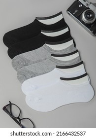 Composition Of Women's Socks On Gray Background. Flat Layout, Table Layout. Top View. Comfortable Footwear For Ladies And Girls. Cozy Women's Hosiery.