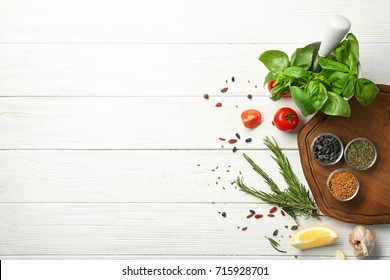 Composition with wooden board and ingredients for cooking on table