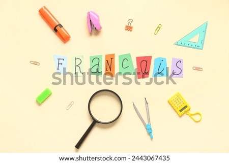 Composition with word FRANCAIS and different stationery on color background