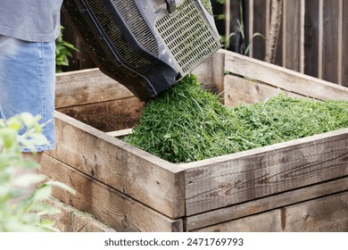 Compost Grass. Making Compost With Grass Clippings. Home Composter - Turns Garden Waste to Fertilizer.  - Powered by Shutterstock